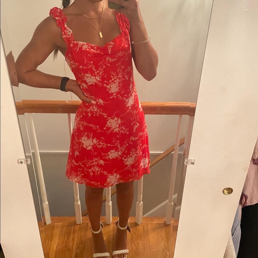 Blood orange dress with white flowers.